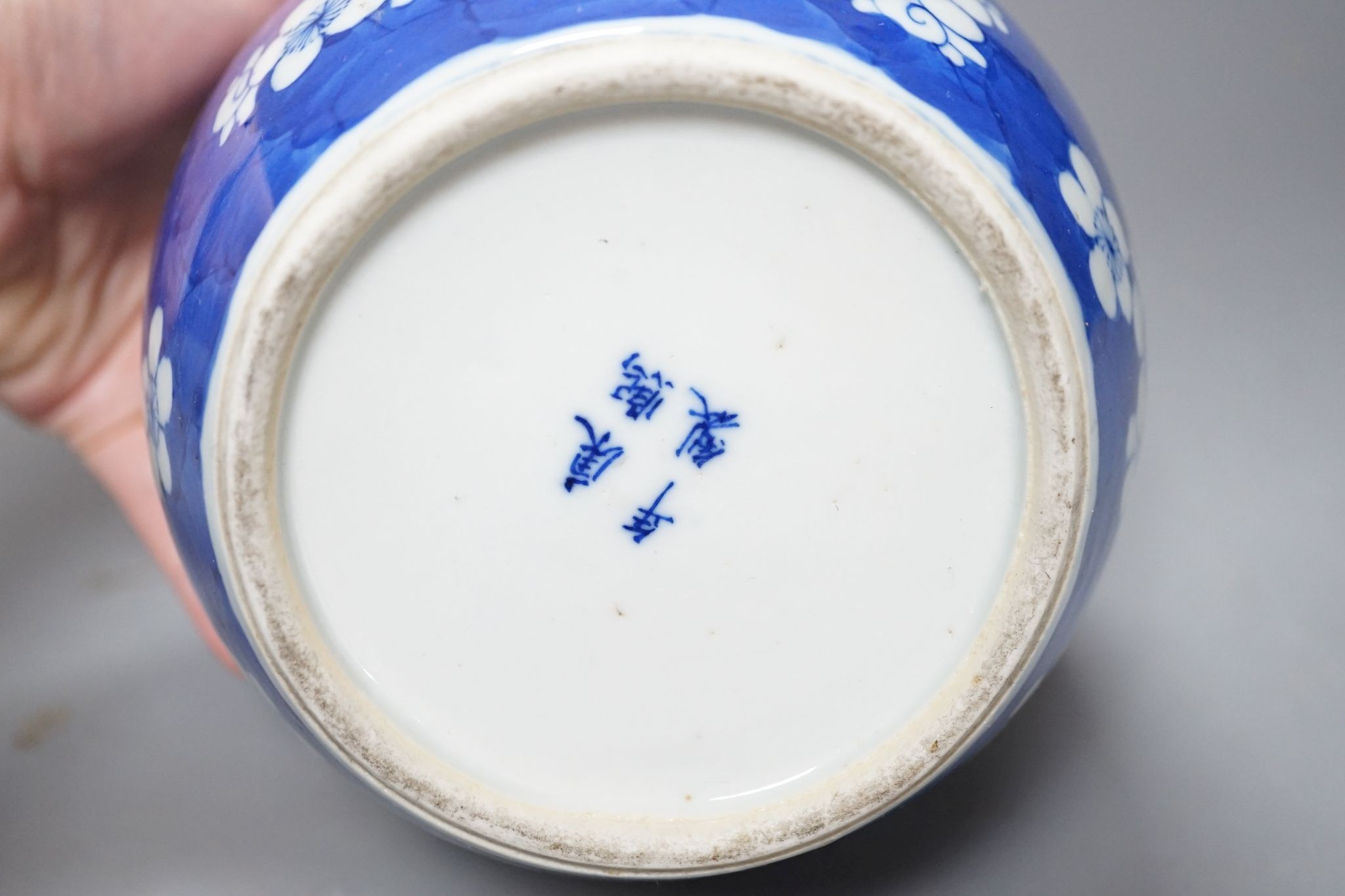 Three Chinese blue and white prunus decorated jars and covers, 19th/20th century, with four character marks 18cm